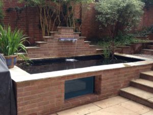 Pond built next to stairs with a cascade