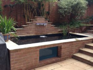 Pond built next to stairs with a cascade